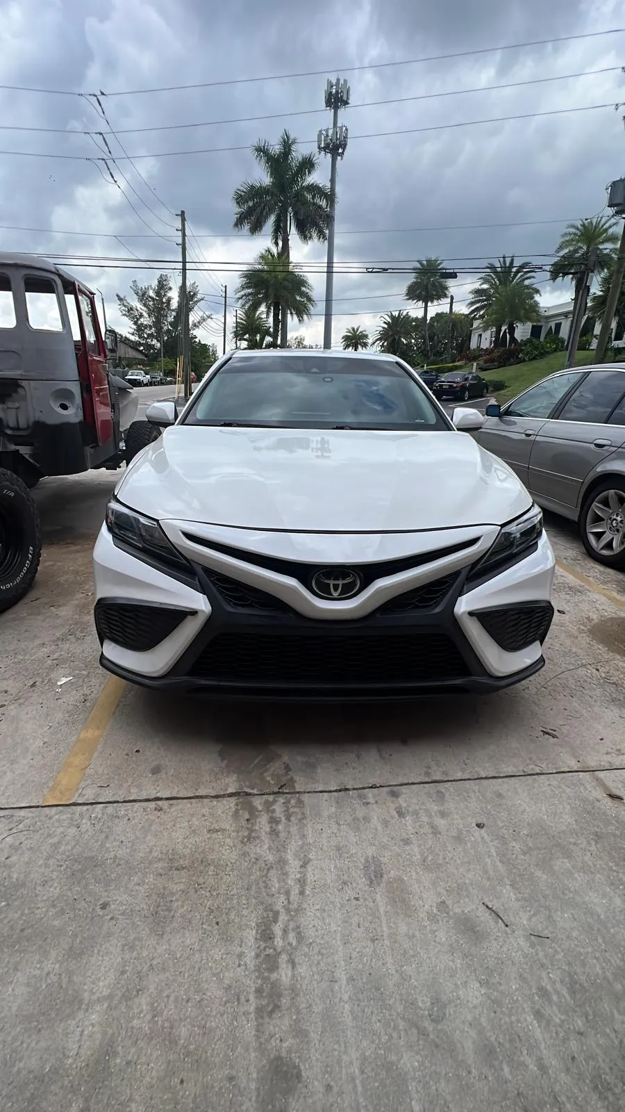 White Toyota Camry finished after bumper repair and paint at the Lake Worth Beach shop