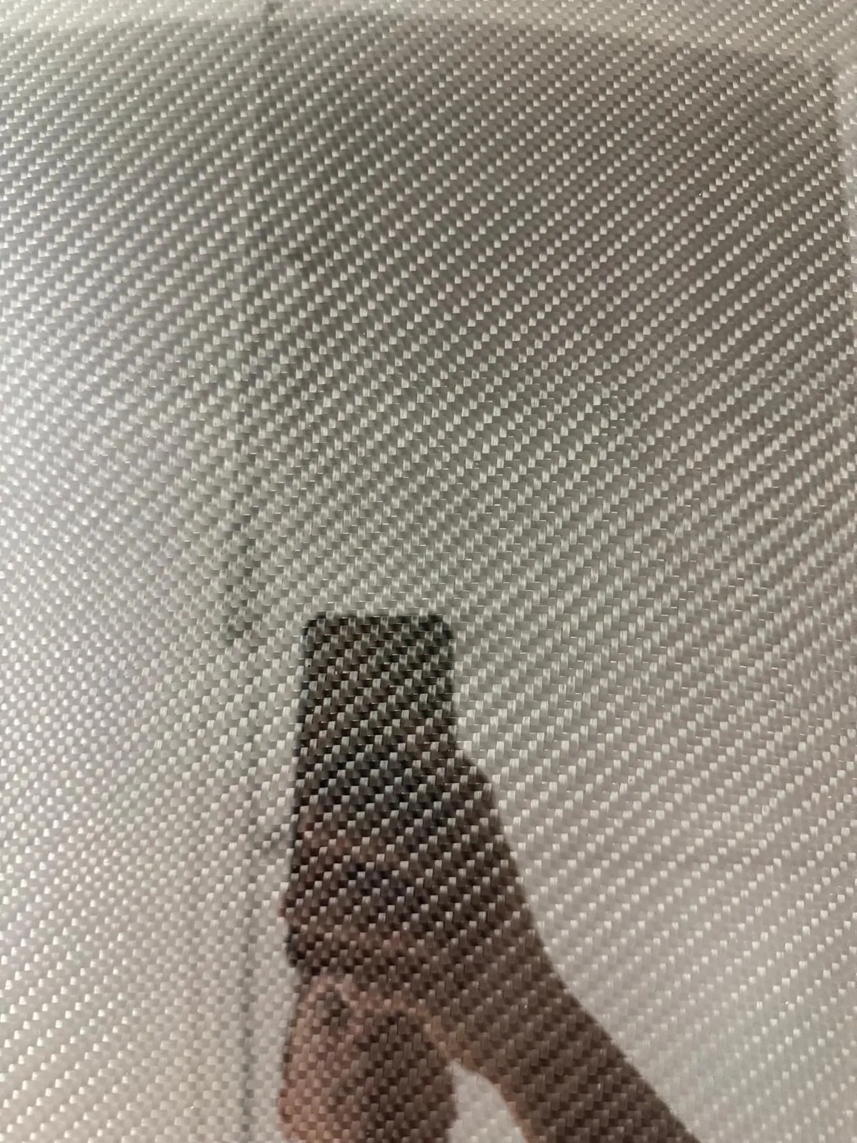 Close-up of carbon fiber weave under a deep clear coat finish