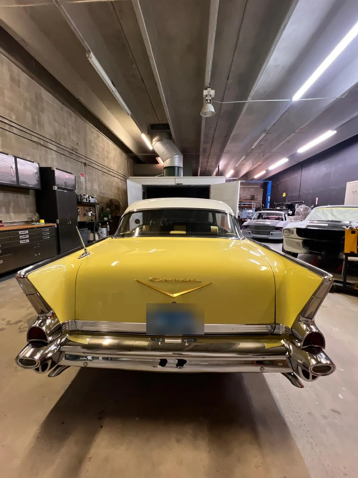 Yellow classic Chevrolet Bel Air inside the Craft Collision shop in Lake Worth Beach