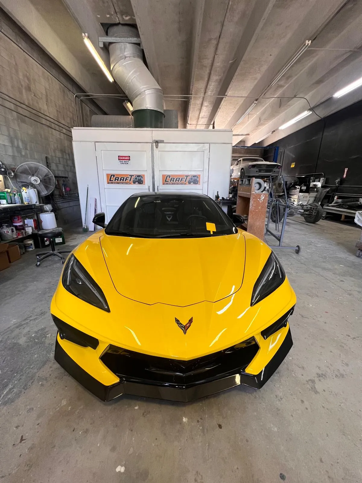 Yellow Chevrolet Corvette C8 in the Craft Collision shop in Lake Worth Beach