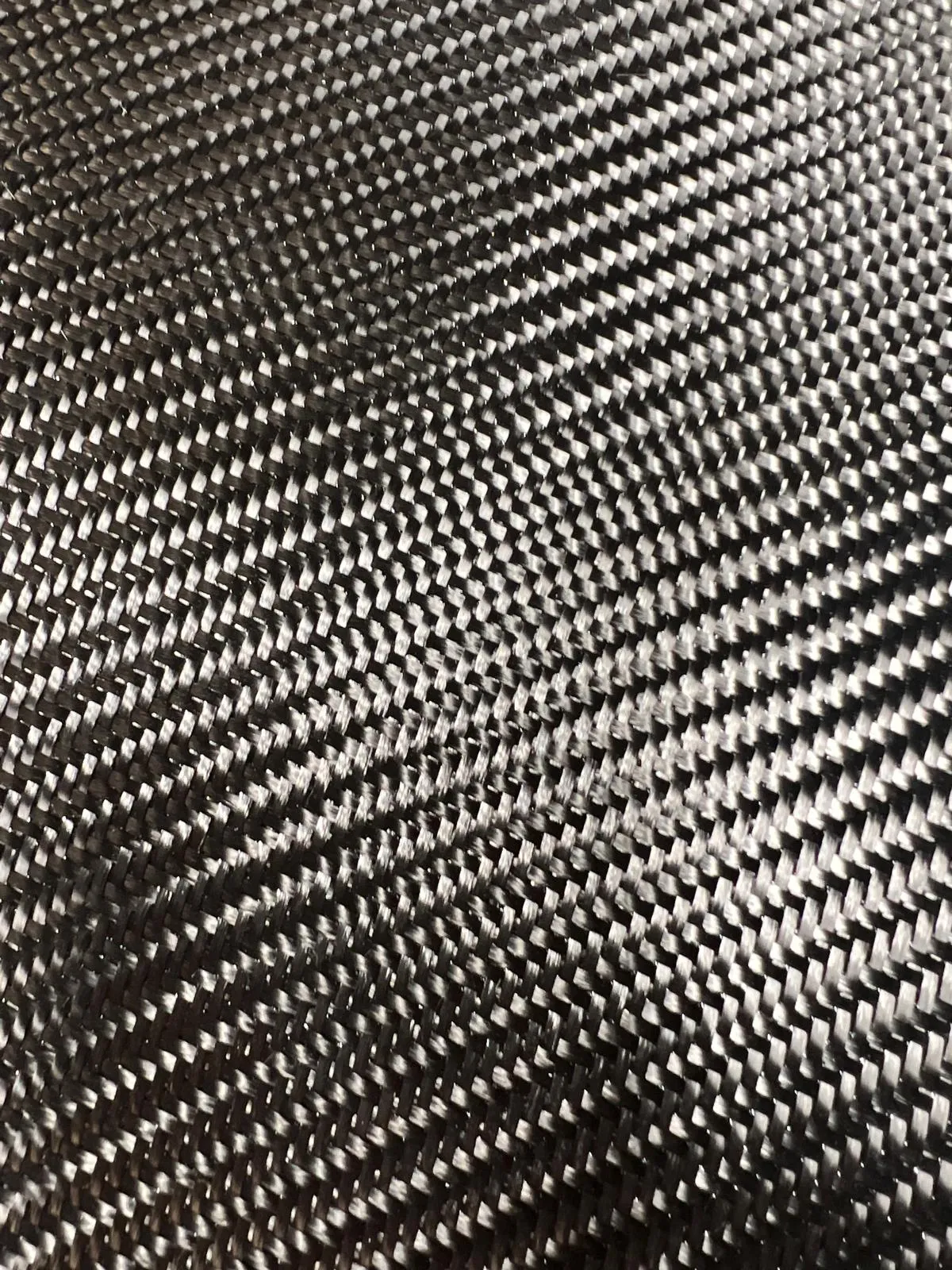 Close-up of dry carbon fiber fabric ready to be laid up into a mold