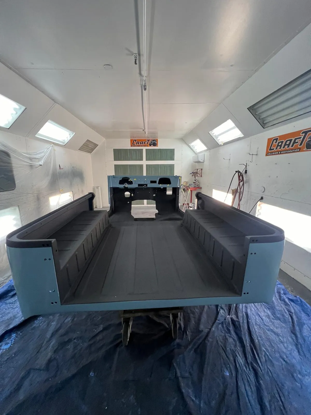 Interior of a Toyota FJ40 bed coated with black spray-in bedliner