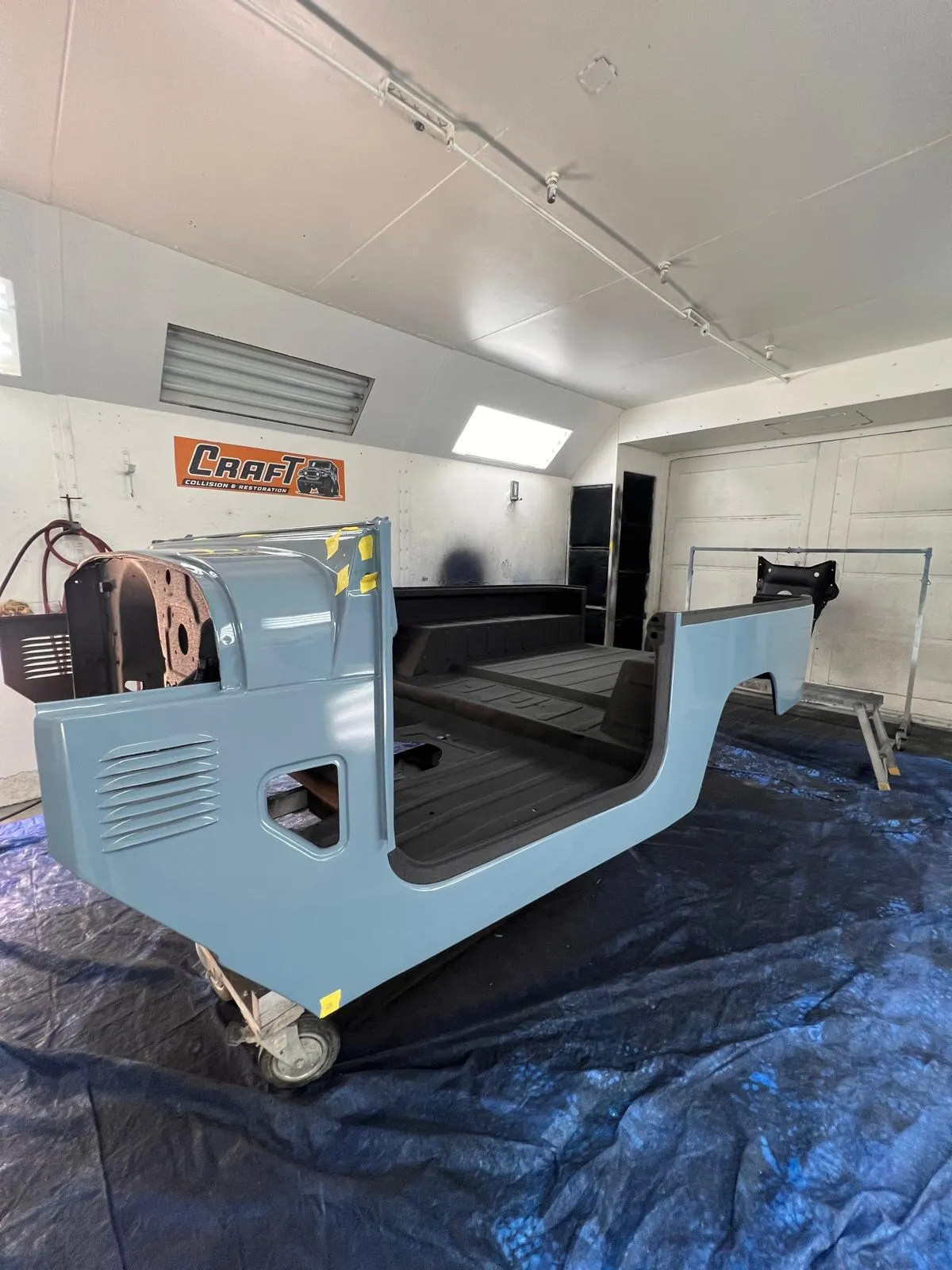 Toyota FJ40 body tub in blue with black bedliner after restoration work