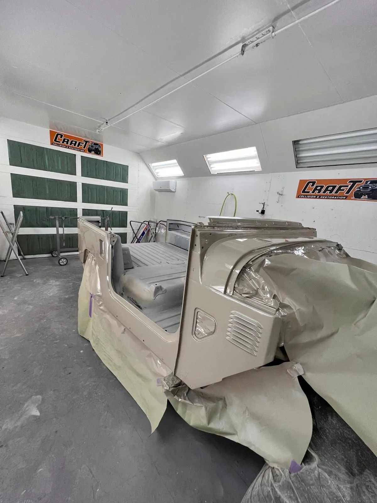 Toyota FJ40 body tub sealed and masked in the booth before the color coat