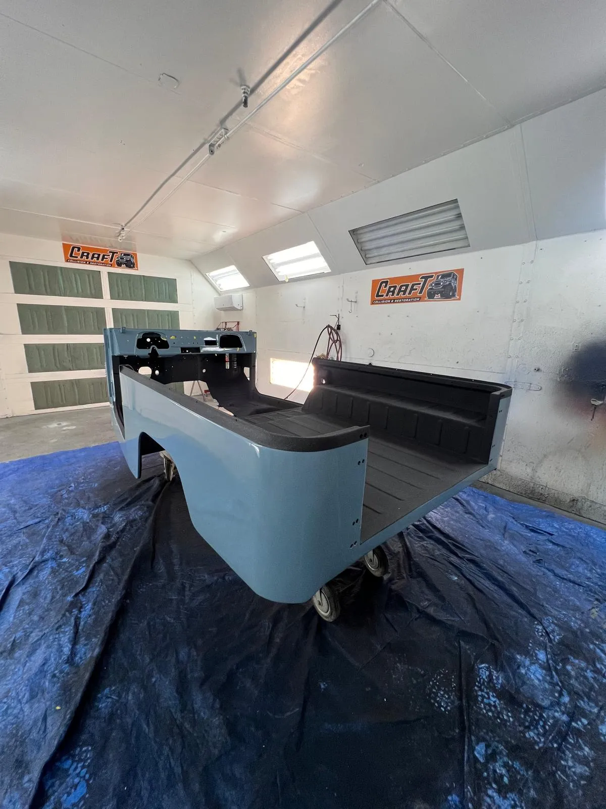 Restored Toyota FJ40 tub with a black spray-in bedliner in the bed