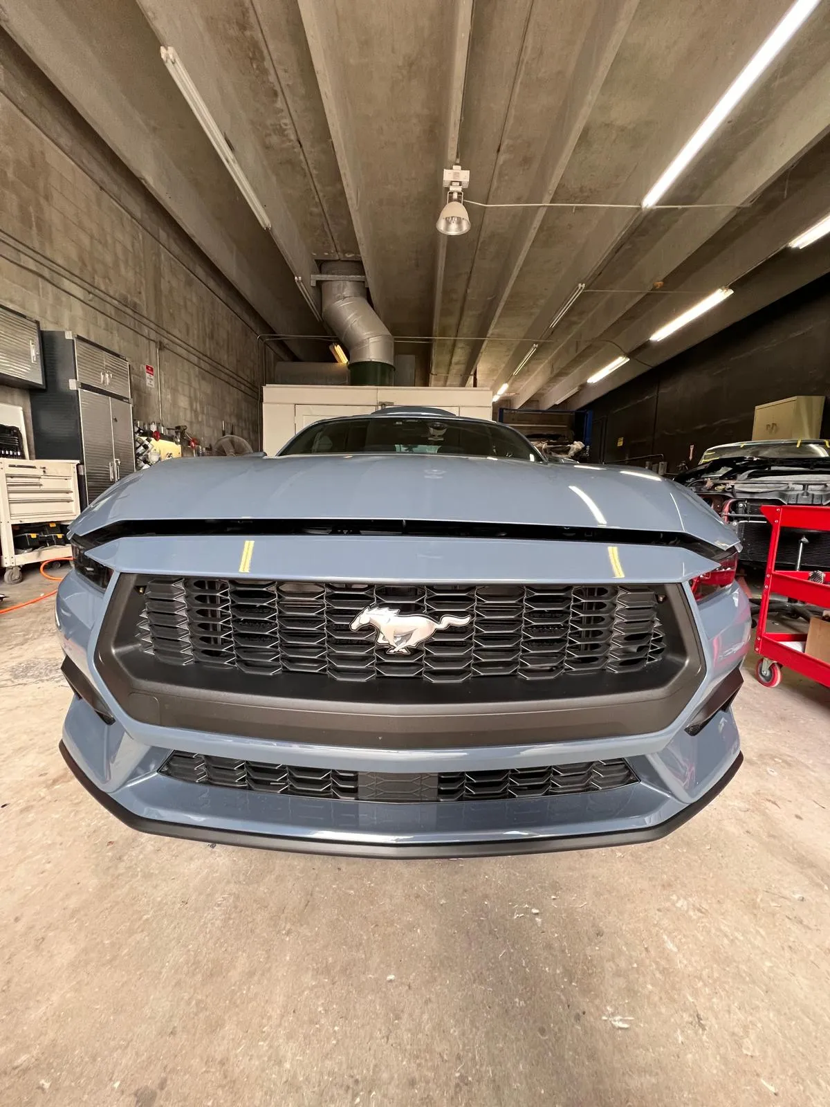 Front end of a silver Ford Mustang after repair at Craft Collision