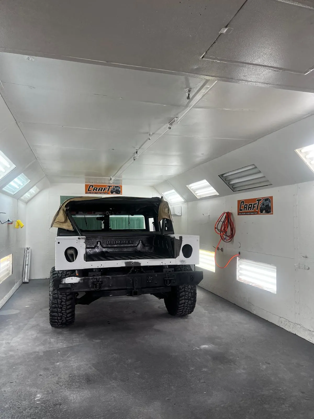Hummer H1 body prepped and primed inside the Craft Collision paint booth