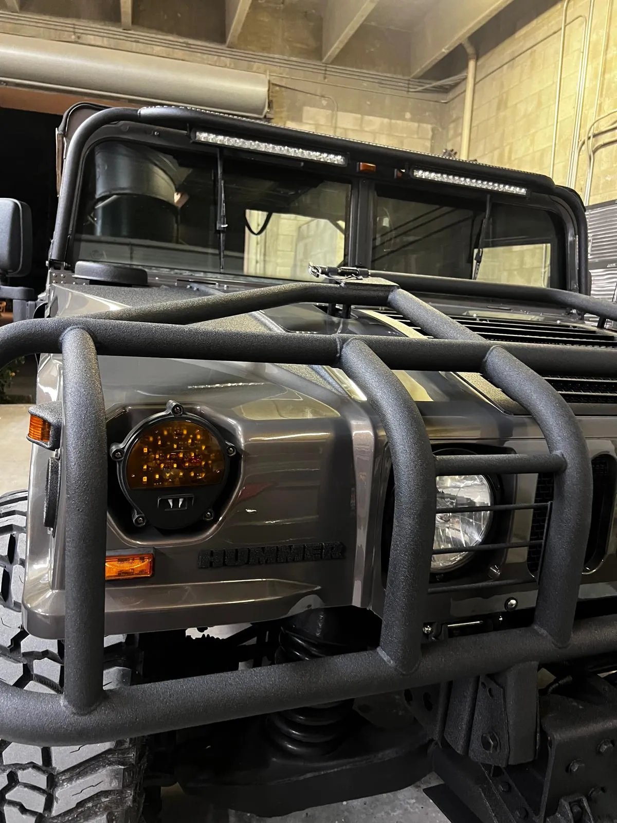 Front end of a Hummer H1 with brush guard after a full respray at Craft Collision