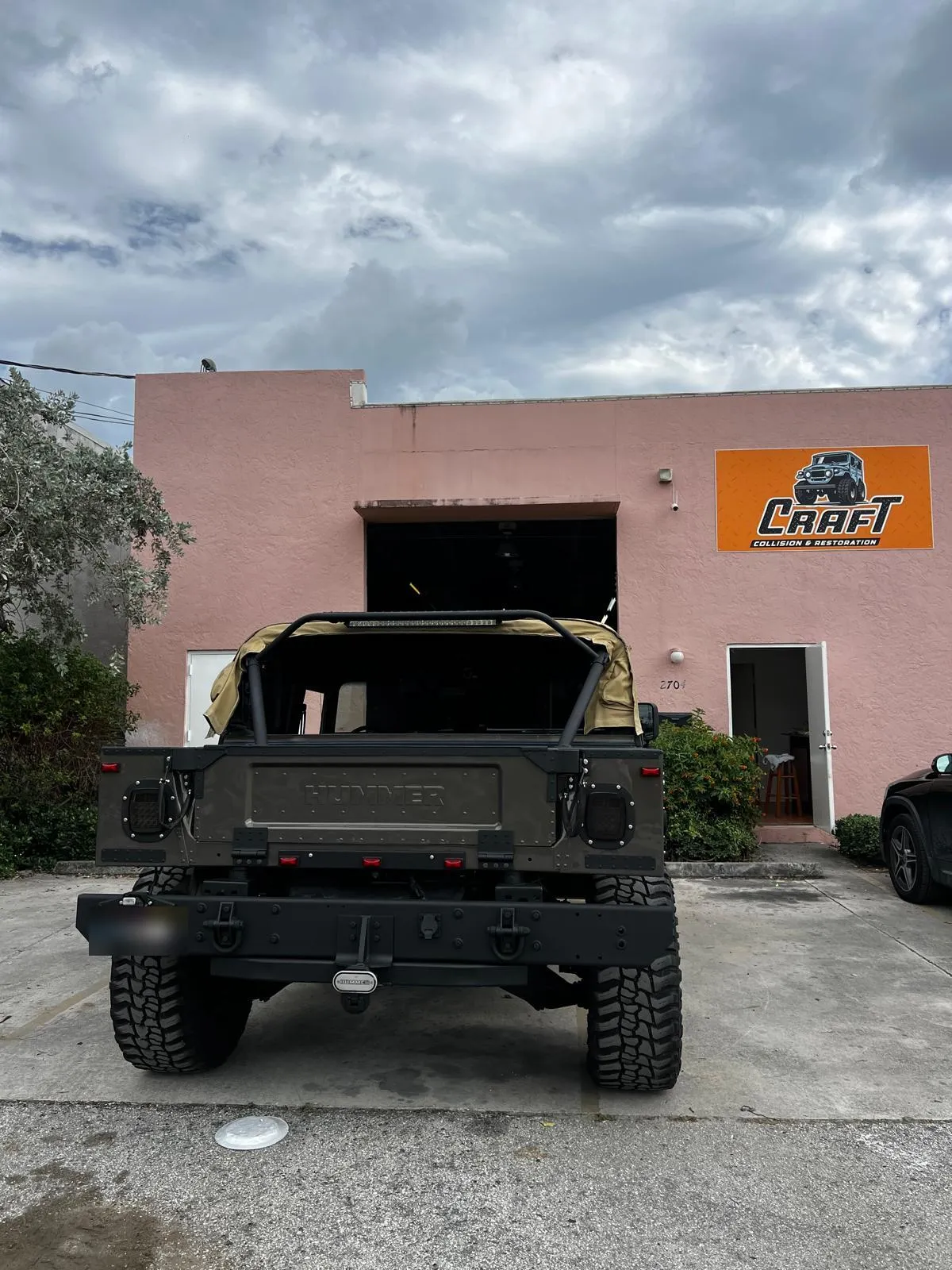 Custom Hummer H1 parked outside the Craft Collision shop in Lake Worth Beach, Florida