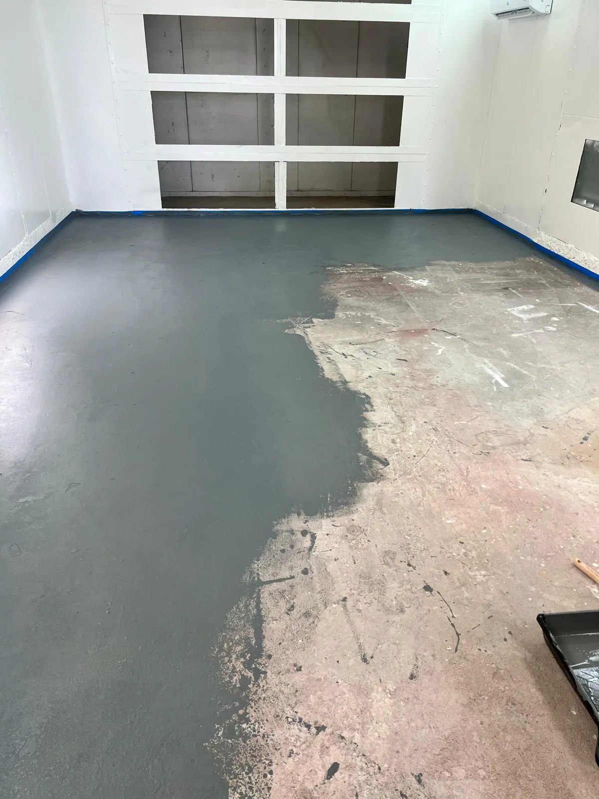 Paint booth floor being refinished at the Craft Collision shop