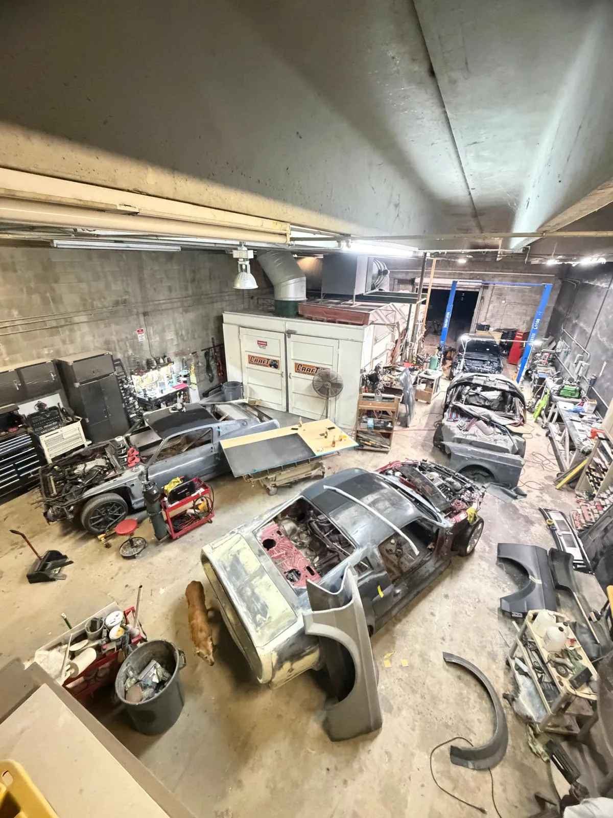 Overview of the restoration side of the Craft Collision shop with several projects in progress
