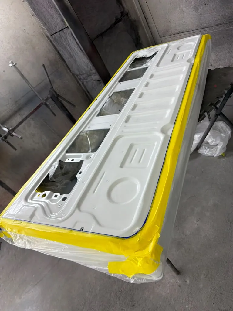 Truck bed and tailgate masked with tape before the spray-in bedliner is applied